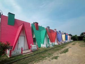 a row of houses painted in different colors at บางกะโดรีสอร์ท Bangkado Resort in Ban Bang Krado