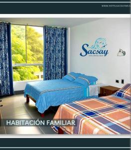 a bedroom with two beds and a sign on the wall at Sacsay Mejía in Islay