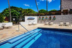 a swimming pool with chairs and a swimming pool at Remodeled 1BR at Kihei Ali'i Kai with Free Parking! in Kihei
