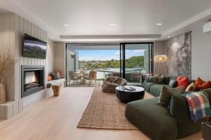 a living room with a couch and a fireplace at The Moorings Apartment 6 - Close to the Lake! in Taupo