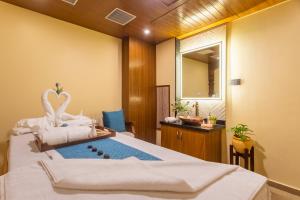 Voodi või voodid majutusasutuse Aarya Hotel and Spa toas