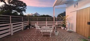 a patio with tables and chairs on a fence at Budget Traveler Only Home in Legazpi