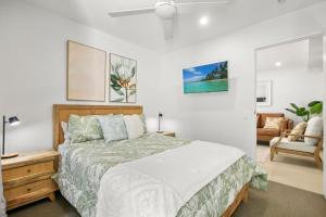 a bedroom with a bed and a living room at Aquaview Unit 103, 29 Canberra Tce, Kings Beach in Caloundra