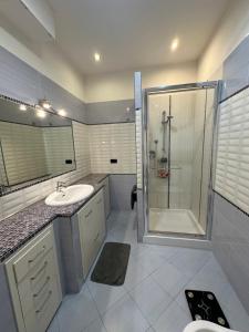 a bathroom with a shower and a sink at Il Tortellino Quasi in Centro Elegant Apartment in Modena