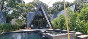 a swimming pool in front of a house at My Cabin by One Selah in Bustos