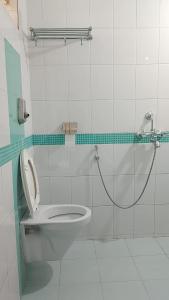 a bathroom with a toilet and a shower at Shangrila Majorda Beach Hotel in Majorda