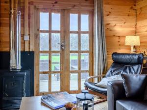a living room with a leather chair and a stove at Halfmoon Wood - Ukc2194 in Caunton