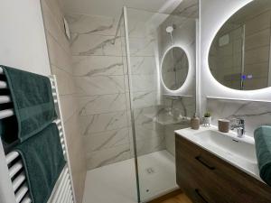 a bathroom with a shower and a sink and a mirror at L'écrin du Lac St-Point in Malbuisson +36 photos