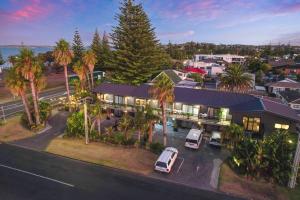 an aerial view of a house with cars parked in a parking lot at Orewa Beachcomber in Orewa