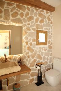 a stone bathroom with a sink and a toilet at Casas Lacambra 7DORMITORIOS con piscina, barbacoa y vistas espectaculares in Tolosa