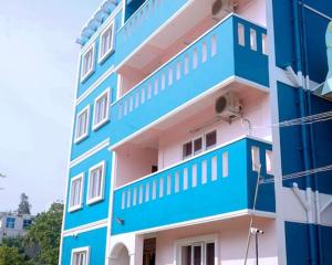 a blue and white building next to a building at RD Resort in Pondicherry