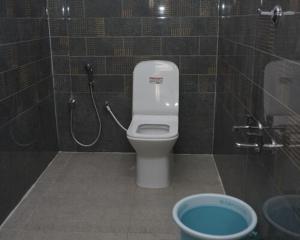a bathroom with a toilet and a shower at RD Resort in Pondicherry