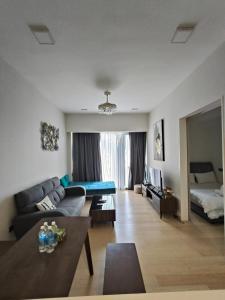 a living room with a couch and a bed at Star KLCC by City Home Plus in Kuala Lumpur
