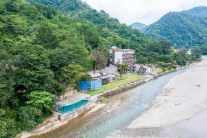 an aerial view of a river next to a mountain at DLS Divine River Resort and Spa, Rishikesh in Rishīkesh