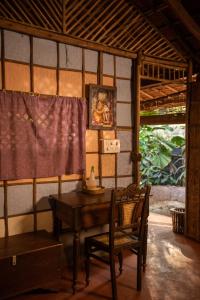 a room with a table and chairs and a window at Bhakti Kutir in Palolem