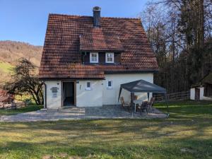 a small white house with a tent in front of it at Haus Bärnstein in Grafenau