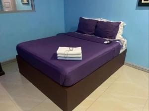 a purple bed with towels on top of it at Bourbon street condo39A in Angeles