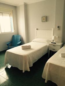 Un ou plusieurs lits dans un hébergement de l'établissement Hostal Acemar