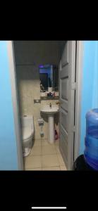 a small bathroom with a toilet and a sink at Bourbon street condo in Angeles