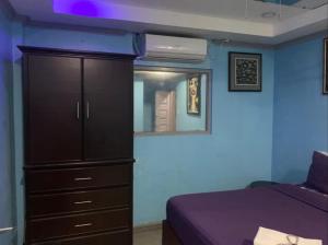 a bedroom with a bed and a dresser and a mirror at Bourbon street condo in Angeles