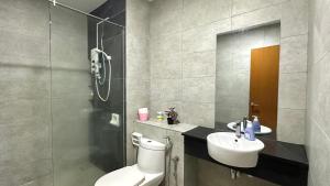 a bathroom with a toilet and a sink and a shower at 2BR Lively City View Family Suite#Airport in Bayan Lepas +11 photos