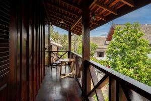 un balcon d'une maison avec une table et des chaises dans l'établissement Villa Mira Heritage, à Luang Prabang