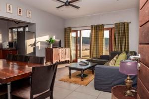 a living room with a table and a dining room at 10onBrightside-Exp the epitome of country living in Nelspruit