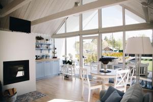 a living room with a fireplace and a table and chairs at RELAX PORT in Bigauņciems