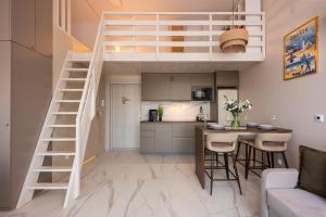 un letto a soppalco in una cucina con tavolo e sedie di Flatbook - Przytulny Apartament w Jantar Resort 307 a Jantar