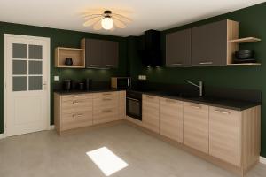 a kitchen with brown cabinets and a green wall at La maison du canal in Champforgeuil