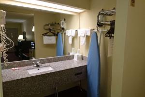 a bathroom with a sink and a mirror at Travelodge by Wyndham Knoxville East in Knoxville