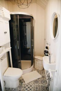 a bathroom with a shower and a toilet and a sink at RELAX PORT in Bigauņciems +33 photos
