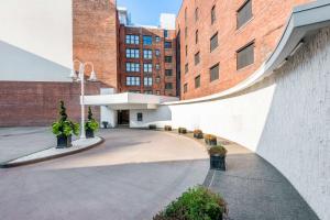 a building with a courtyard with plants and buildings at Curtiss Hotel, an Ascend Collection Hotel in Buffalo