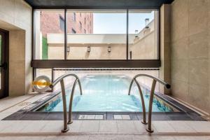 a jacuzzi tub in a building with a large window at Curtiss Hotel, an Ascend Collection Hotel in Buffalo