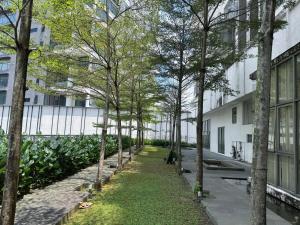 a corridor of trees in front of a building at Comfy Studio Neo Damansara Ikea Ikano 2Pax1CP in Petaling Jaya