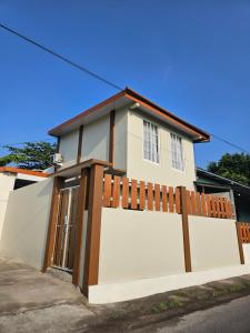 a white house with a gate and a fence at Aso Living in Bantul