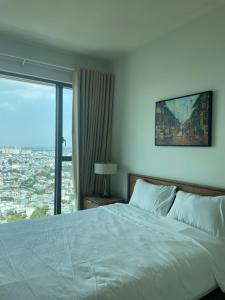 a bedroom with a bed and a large window at 1Br Feliz apartment ThanhMyLoi in Ho Chi Minh City