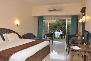 En eller flere senger på et rom på Blue Country Resort