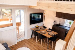 a dining room with a table in a tiny house at White Nights holiday home with sauna and grill in Pärnu