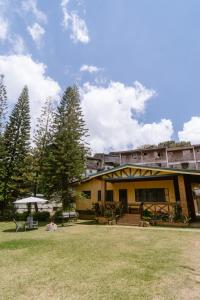 a building in a park with a grass field at Baguio City Cabin House in Baguio