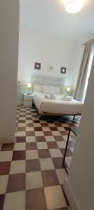 Łóżko lub łóżka w pokoju w obiekcie Casas y Patios de Sevilla