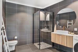 a bathroom with a toilet and a sink and a mirror at ROOF HOUSE, Downtown in Sandefjord in Sandefjord