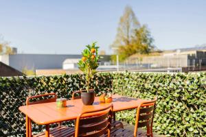a wooden table and chairs on a patio at Smart 50m2 One Bedroom Apartment - VW140C in Eindhoven +37 photos