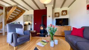a living room with two couches and a table at Seespatz in Diemelsee