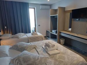 Postel nebo postele na pokoji v ubytování Blue Bay Hotel