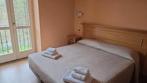 Postelja oz. postelje v sobi nastanitve Albergo Minetto