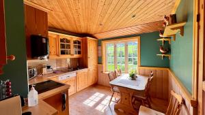 a kitchen with a table and chairs in a room at Sognefjorden-Vik i Sogn in Brekka