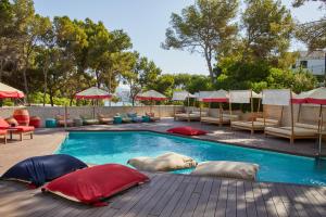 two polar bears laying on pillows in a swimming pool at Alua Calvia in Magaluf