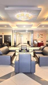 a large lobby with couches and a chandelier at Hotel Seri Malaysia Kepala Batas in Kepala Batas