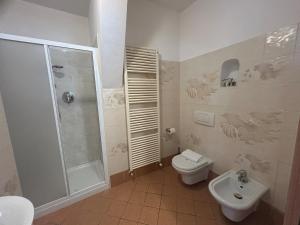a bathroom with a shower and a toilet and a sink at Living Apartment-Centro Storico-Autodromo in Imola